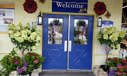 doors with welcome sign and flowers