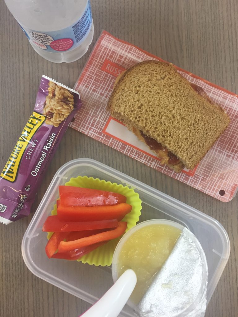 packed school lunch with PB&J, applesauce, granola bar and applesauce