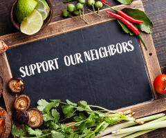 support our neighbors black board with veggies