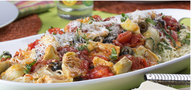 Italian pasta salad in serving dish on table