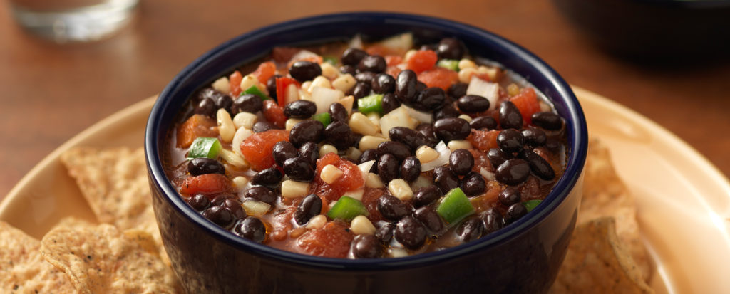 black bean salsa in bowl surrounding by tortilla chips