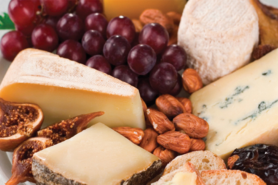 Assortment of cheeses, nuts and grapes