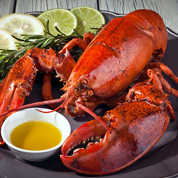 lobster with butter sauce and sliced limes