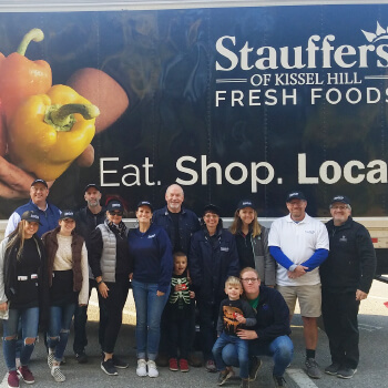 group of stauffers employees in front of a stauffers truck
