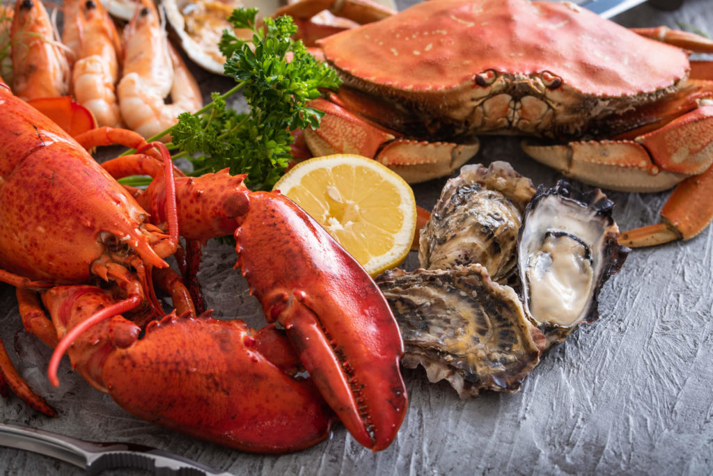 A variety of fresh, local seafood including lobsters, shrimp, and crabs.