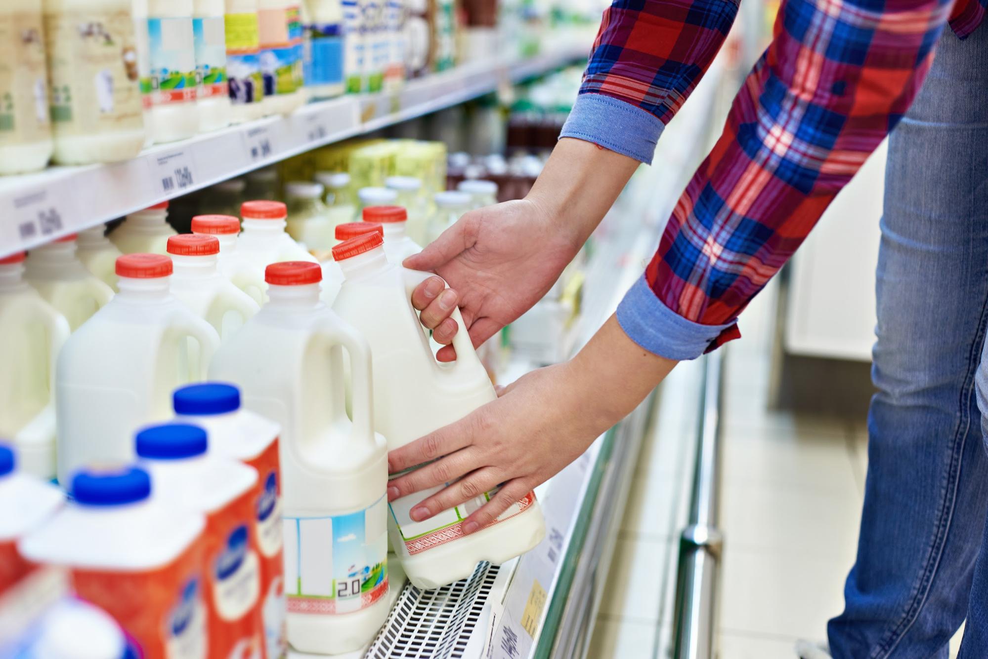 A person buys milk at the grocery store.