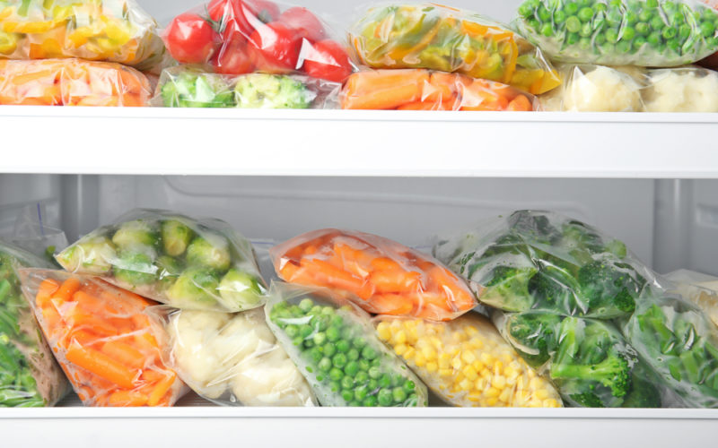 A freezer full of frozen fruits and vegetables.