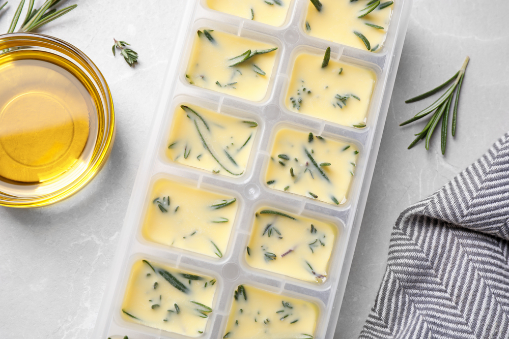 Freezing herbs in olive oil helps them maintain their flavor long-term in the freezer.