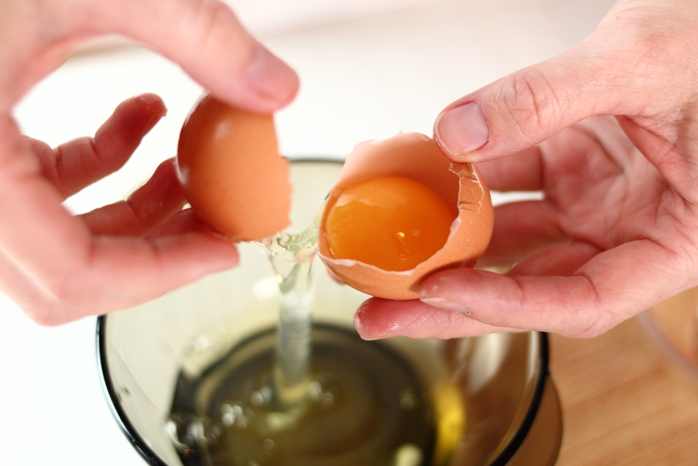 Cracking an egg in preparation for freezing.