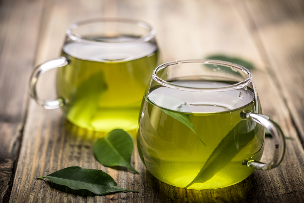 Clear mugs of green tea