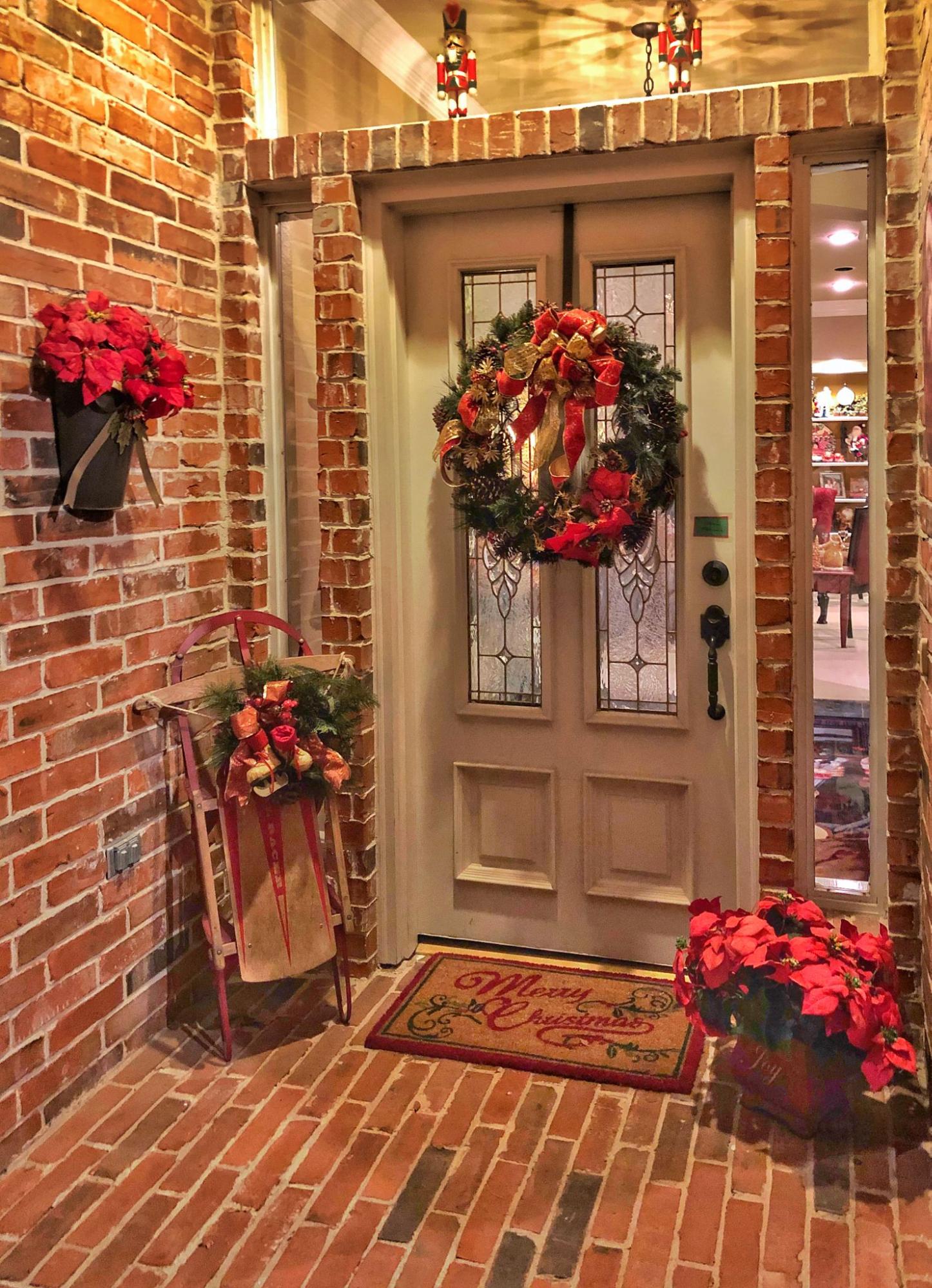 A Christmas sled display on a front porch