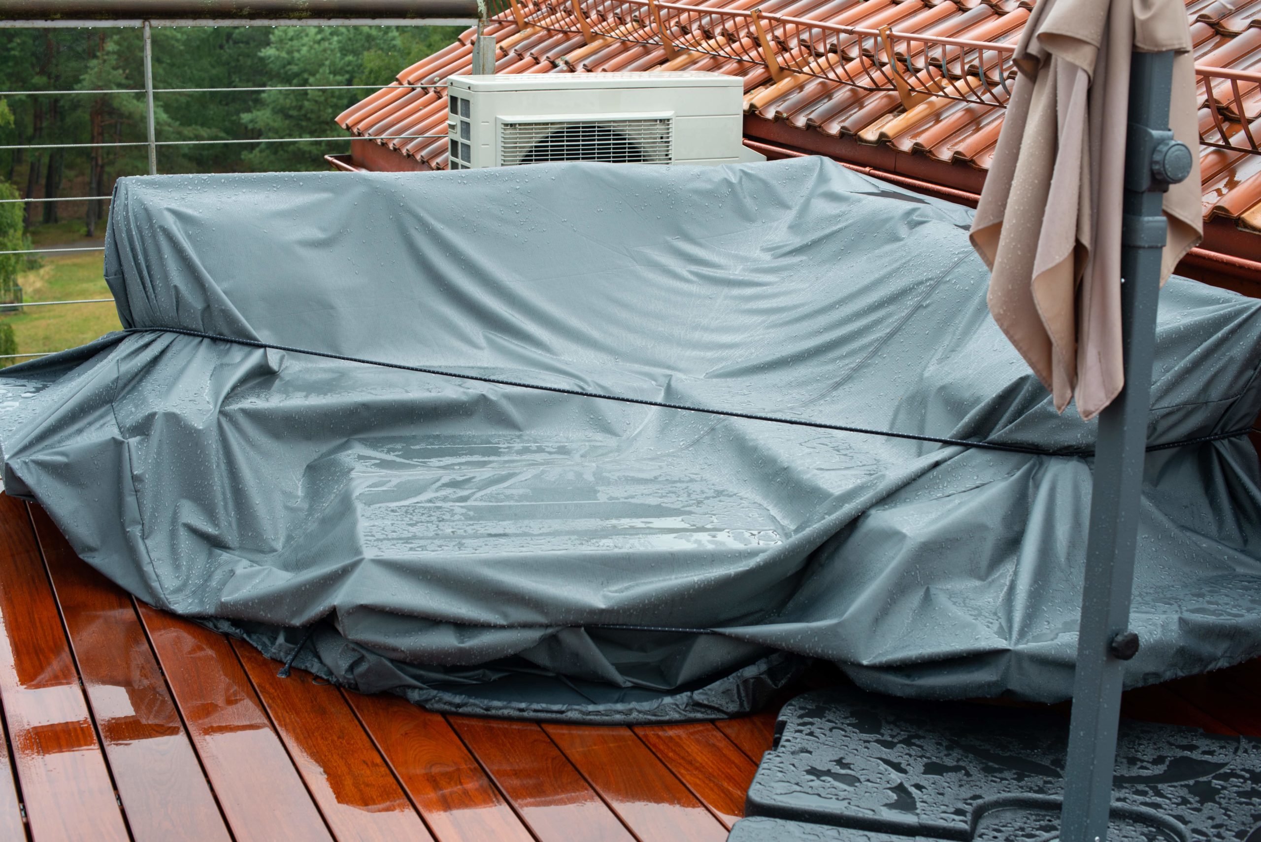 Patio furniture covered with waterproof tarp.