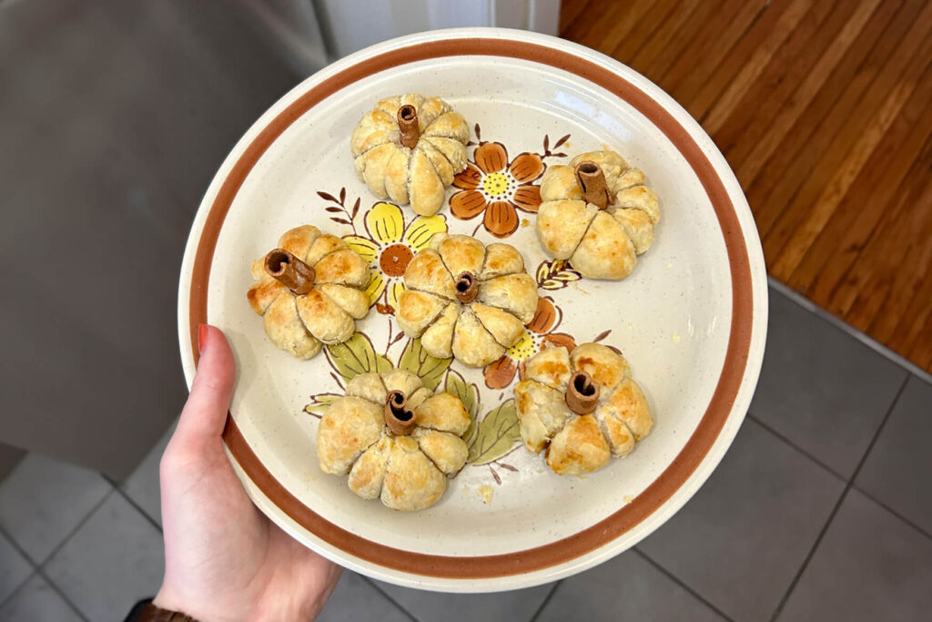 6 mini brie pumpkins on a plate for an easy Thanksgiving appetizer