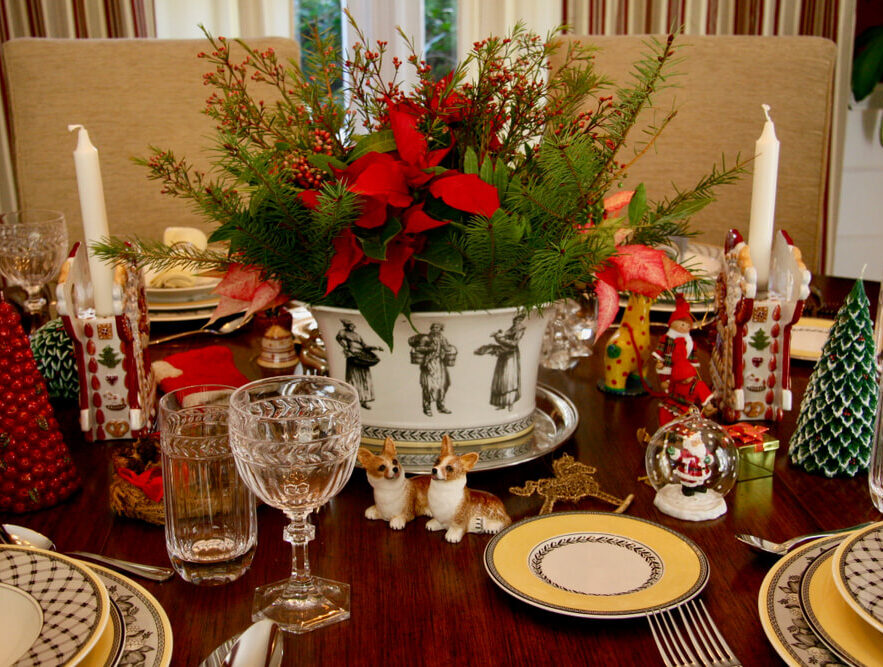 Holiday plants centerpiece in the middle of a table set for a nice dinner