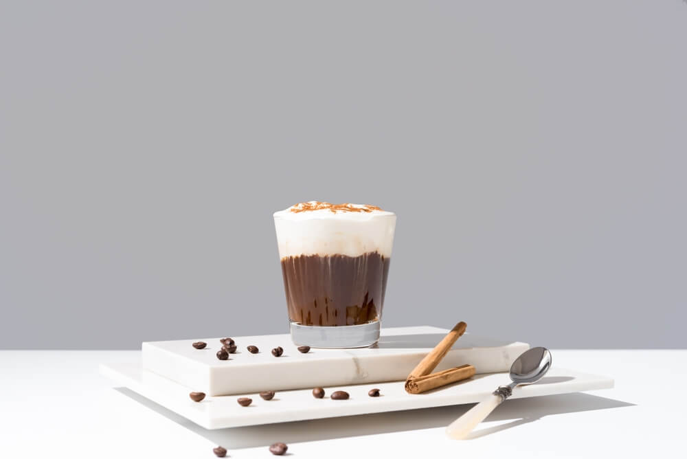 Christmas mocktail tiramisu shot in a clear class with espresso beans next to it