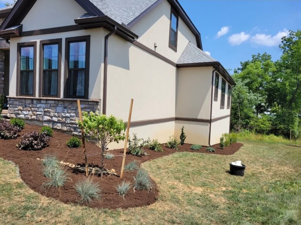 Mulched landscaping in front of a white house in Lititz, PA